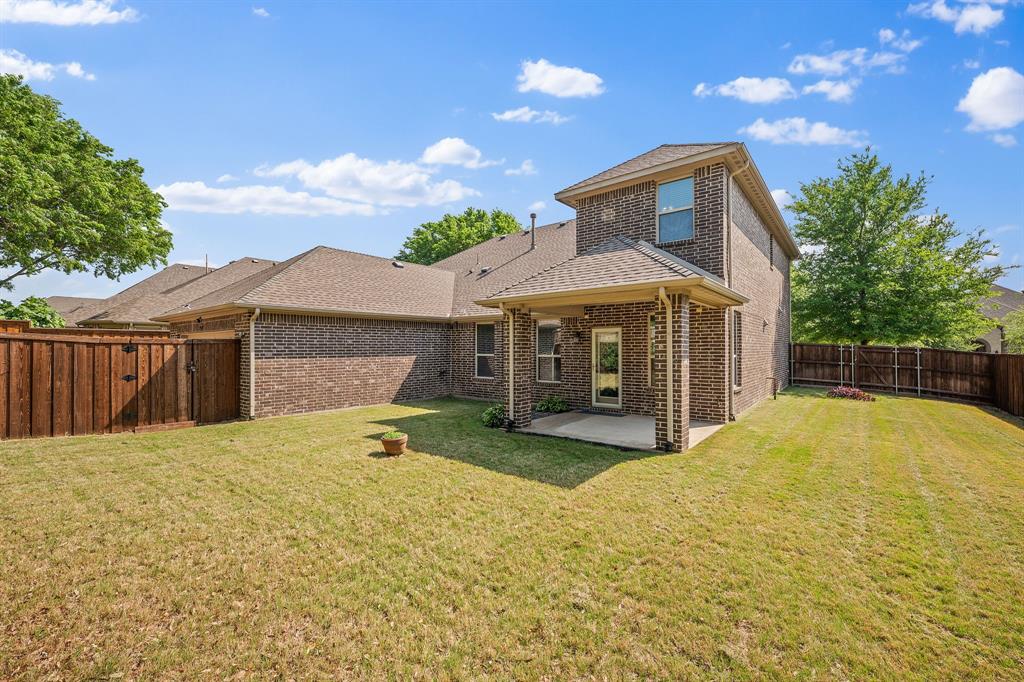 12809 Spring Hill Drive Frisco, TX 75035 - Photo 5 of 37 a front view of a house with a yard and garage