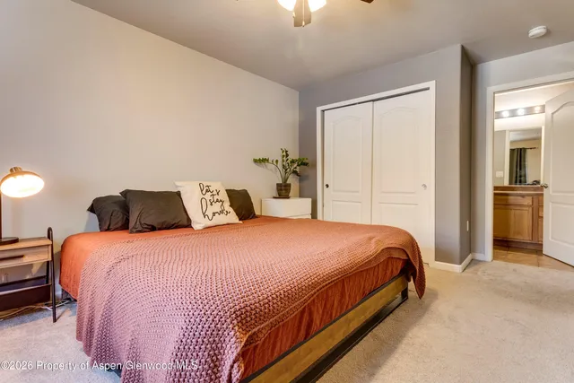 a bedroom with a bed and painting on the wall