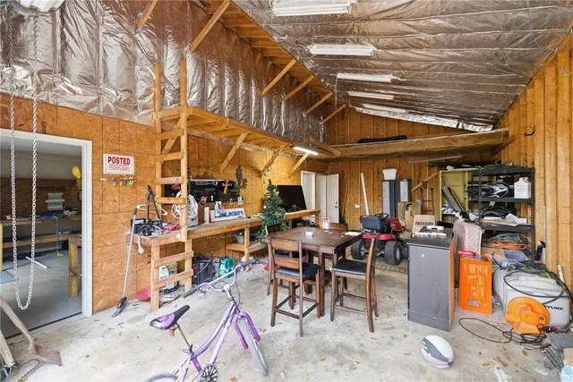 an aerial view of residential house with outdoor space and trees