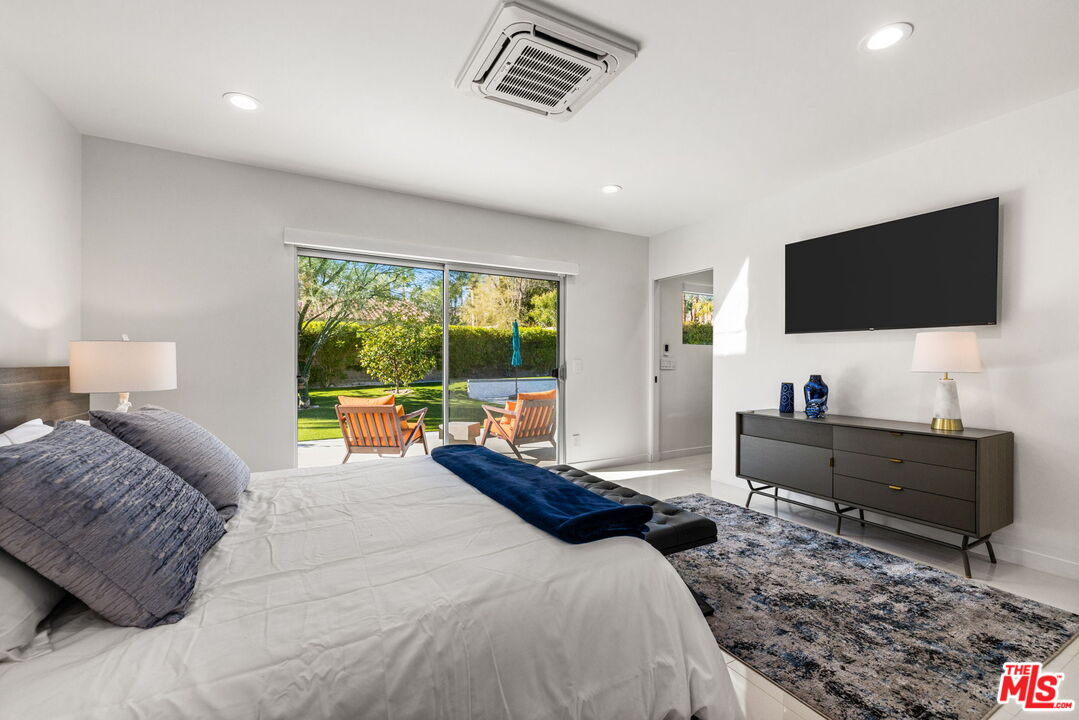 71581 Halgar Road Rancho Mirage, CA 92270 - Photo 22 of 39 a bedroom with a bed and large window