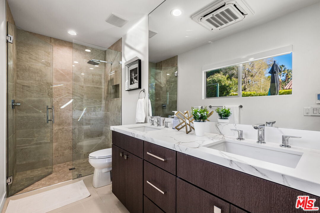 71581 Halgar Road Rancho Mirage, CA 92270 - Photo 23 of 39 a bathroom with a double vanity sink toilet and shower