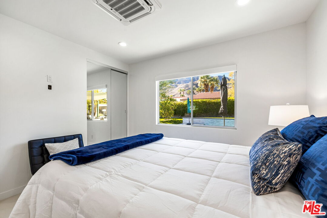 71581 Halgar Road Rancho Mirage, CA 92270 - Photo 25 of 39 a bedroom with a bed and a window