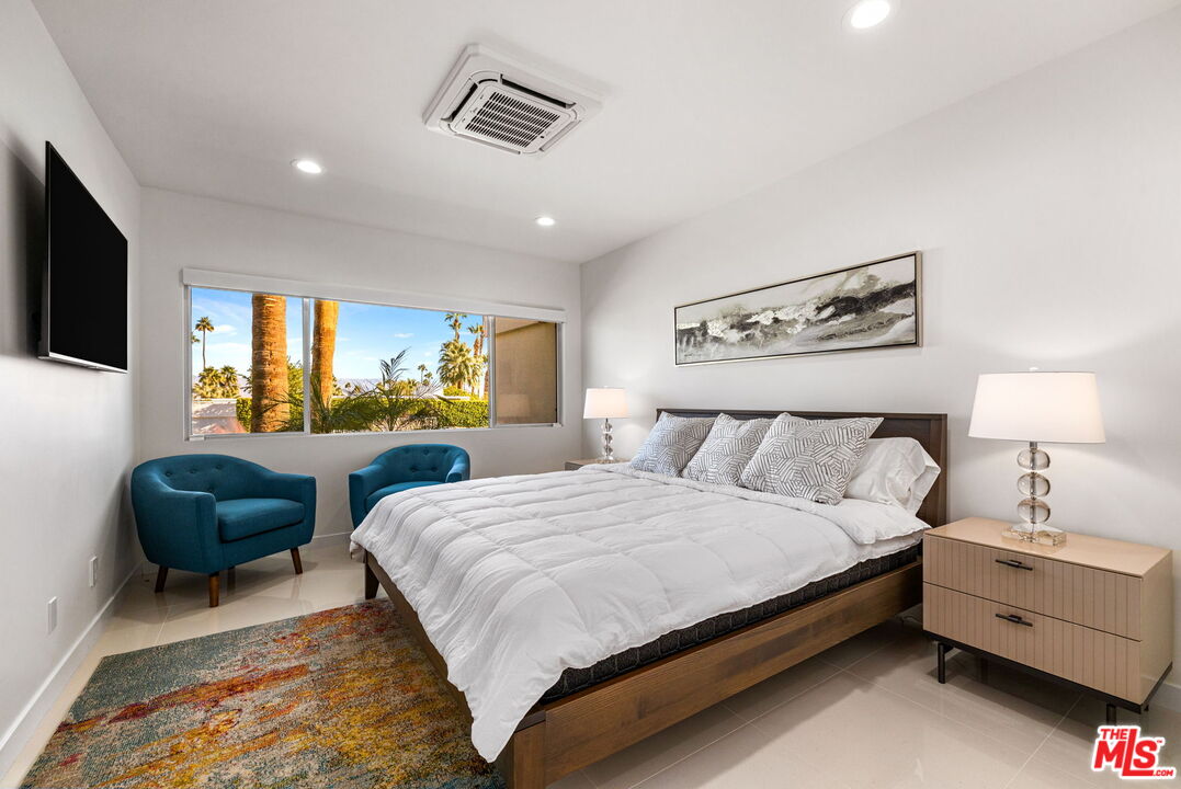 71581 Halgar Road Rancho Mirage, CA 92270 - Photo 27 of 39 a bedroom with a bed and a couch