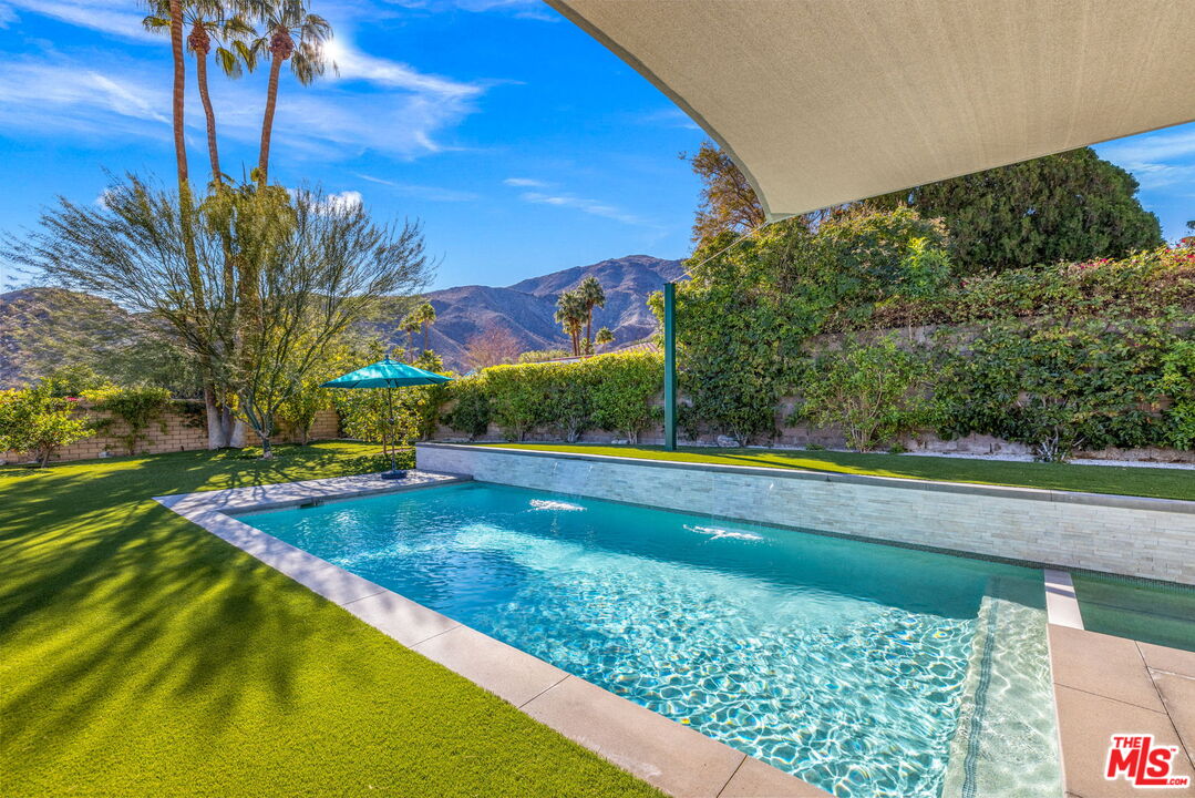 71581 Halgar Road Rancho Mirage, CA 92270 - Photo 35 of 39 a view of a swimming pool with an outdoor seating and a yard