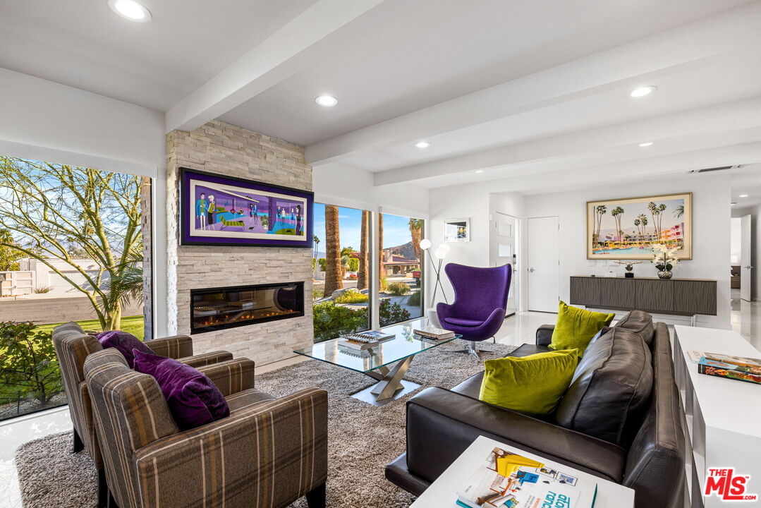71581 Halgar Road Rancho Mirage, CA 92270 - Photo 5 of 39 a living room with furniture fireplace and a large window