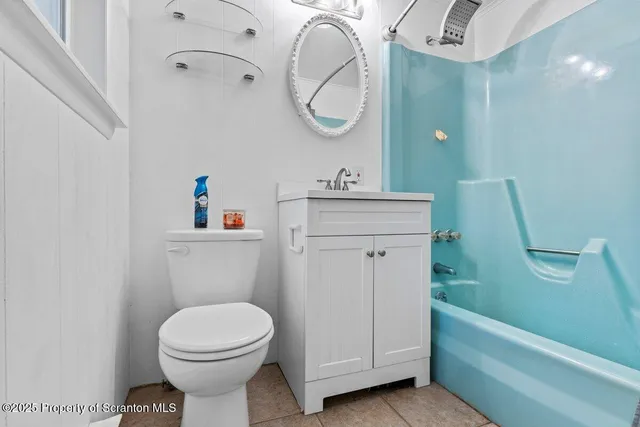 a bathroom with a toilet a sink and bathtub