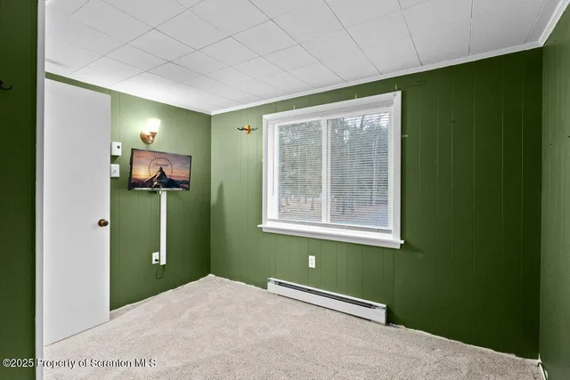 a view of a room that has a fan and window in it