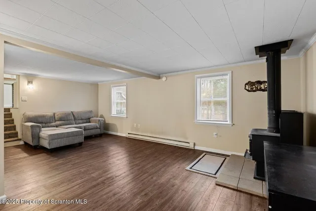 a living room with furniture and a flat screen tv with wooden floor