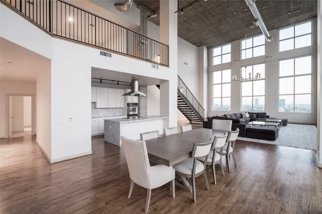 a view of a dining room with furniture a chandelier and wooden floor