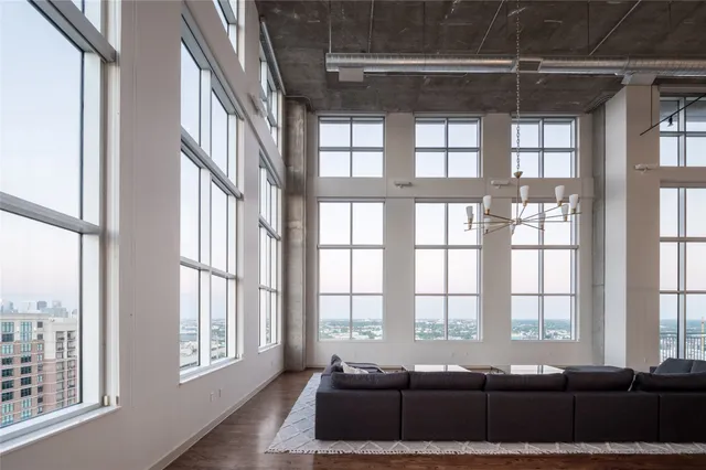 a living room with furniture and large windows