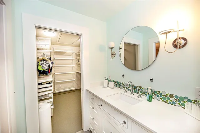 a bathroom with a sink a mirror and a shower