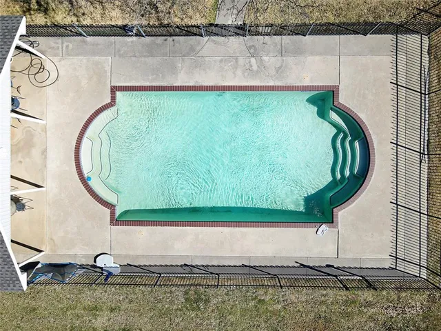 a bathroom with a bathtub and mirror
