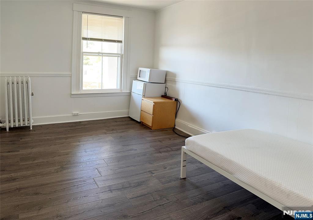 115 West Allendale Avenue, Unit 7 Allendale, NJ 07401 - Photo 2 of 10 an empty room with wooden floor and windows