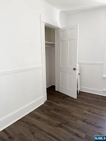 an empty room with wooden floor