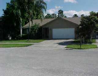 3918 Walnut Place Stuart, FL 34997 - Photo 1 of 1 a front view of a house with a yard and garage