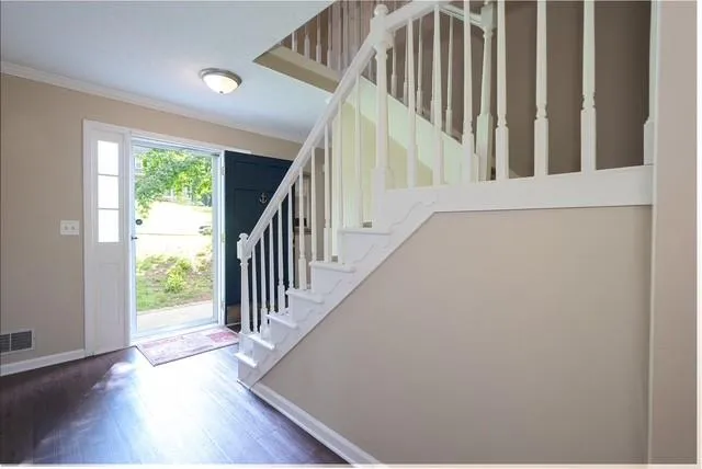 a view of staircase with wooden floor and a window