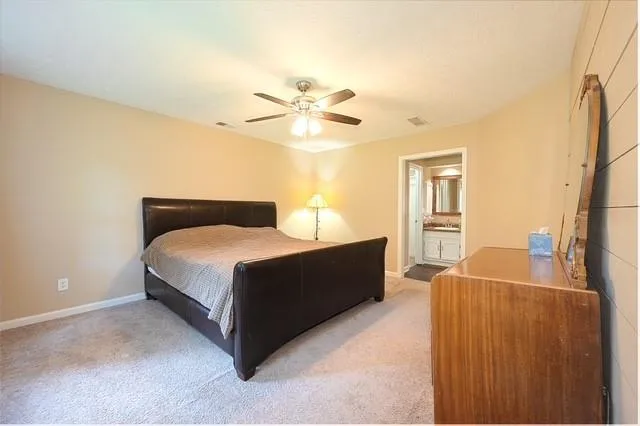 a bedroom with a bed dresser and a window