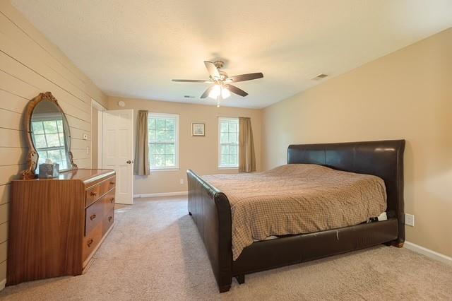 26 Flint Ridge Drive Southeast Mableton, GA 30126 - Photo 20 of 28 a bedroom with a large bed and a chandelier