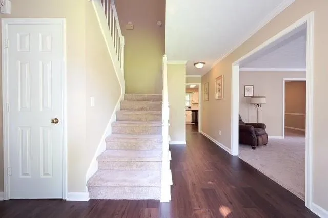 a view of a hallway view with wooden floor and staircase