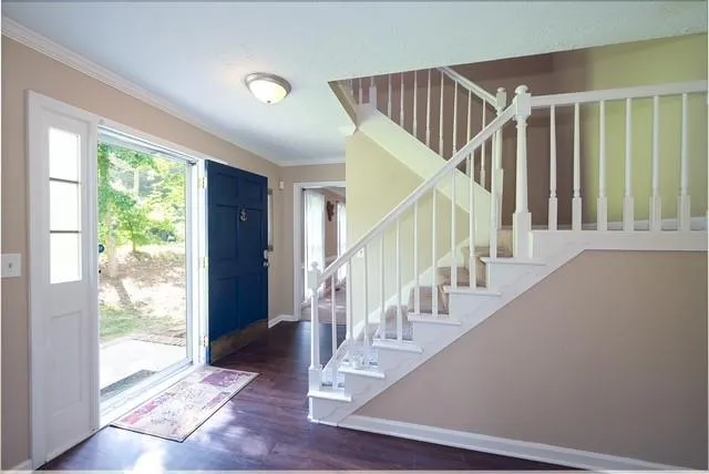 a view of entryway and hall with wooden floor