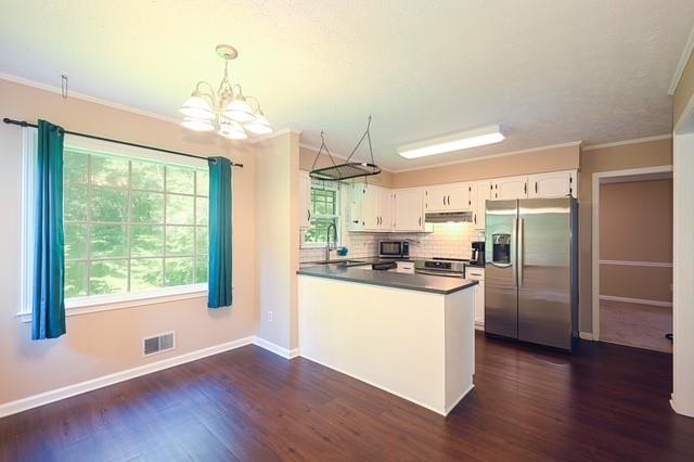 26 Flint Ridge Drive Southeast Mableton, GA 30126 - Photo 9 of 28 a kitchen with stainless steel appliances granite countertop a refrigerator a sink dishwasher a stove and a dining table with wooden floor