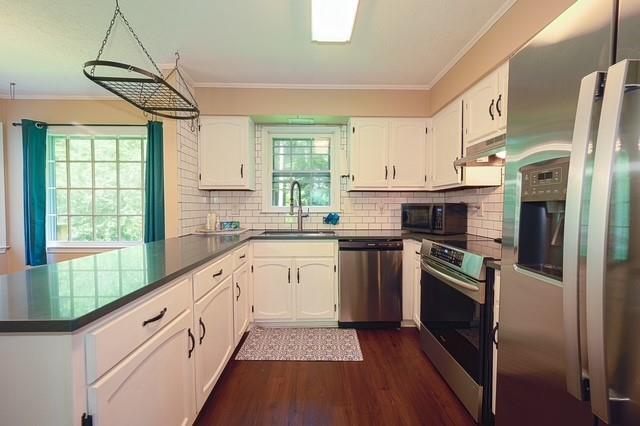 26 Flint Ridge Drive Southeast Mableton, GA 30126 - Photo 10 of 28 a kitchen with stainless steel appliances granite countertop a stove a sink and a refrigerator