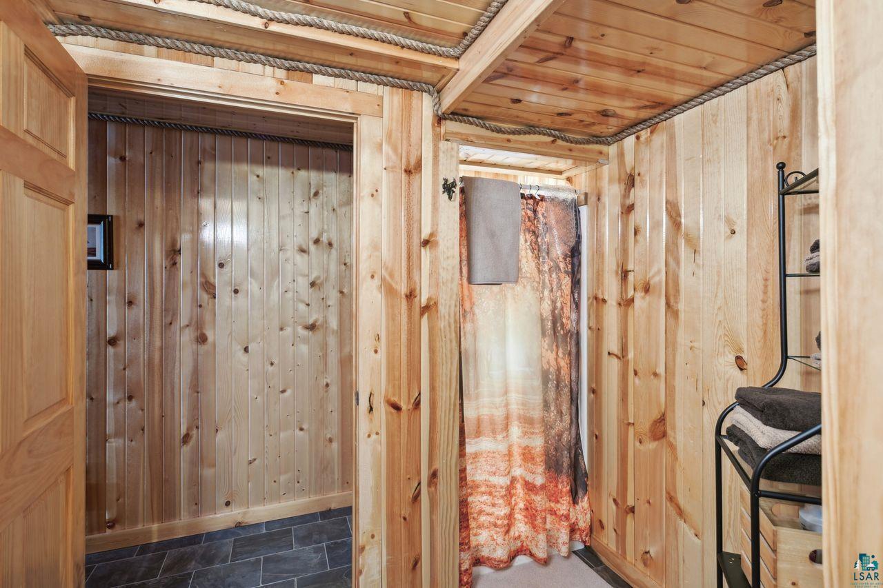 28255 Friendly Valley Road Washburn, WI 54891 - Photo 22 of 34 Bathroom with wood walls and wooden ceiling