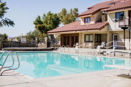 415 Tepatitlan Court Ridgecrest, CA 93555 - Photo 31 of 33 a view of a white house with a large pool table and chairs