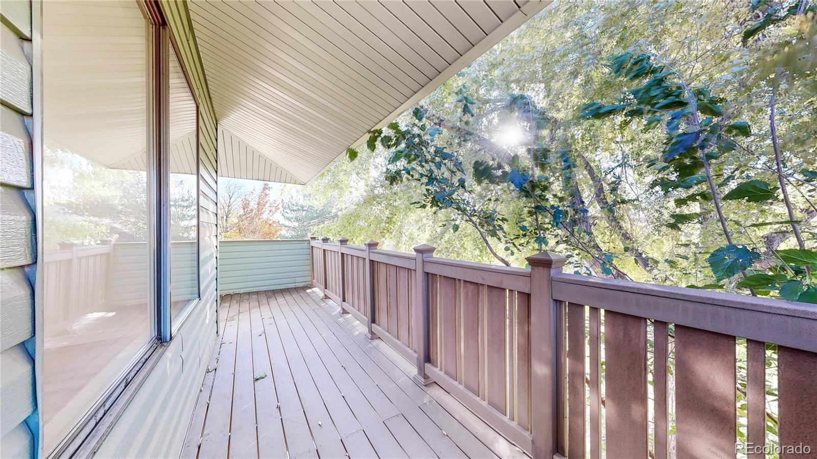1800 Ionic Drive, Unit C Lafayette, CO 80026 - Photo 16 of 19 a balcony with wooden floor and fence