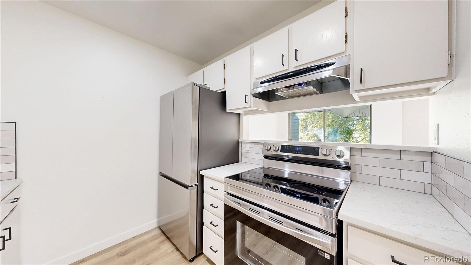1800 Ionic Drive, Unit C Lafayette, CO 80026 - Photo 6 of 19 a kitchen with stainless steel appliances a sink cabinets and a window