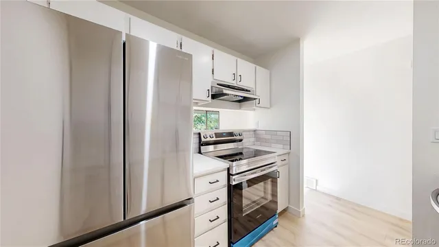 a kitchen with stainless steel appliances a refrigerator stove and microwave