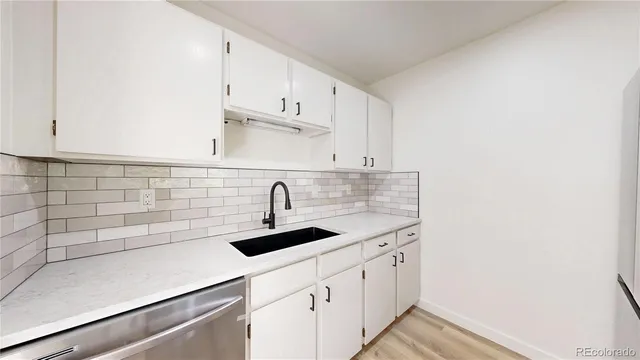 a kitchen with a sink and cabinets