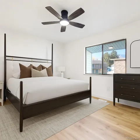 a bedroom with a large bed and a dresser