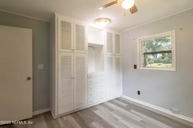 an empty room with windows and closet