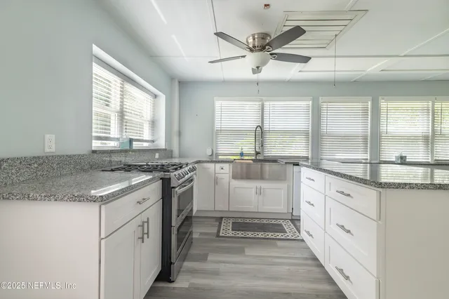 a kitchen with stainless steel appliances granite countertop a stove and a sink