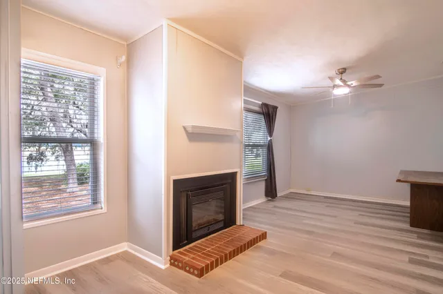 a view of a livingroom with a fireplace and window