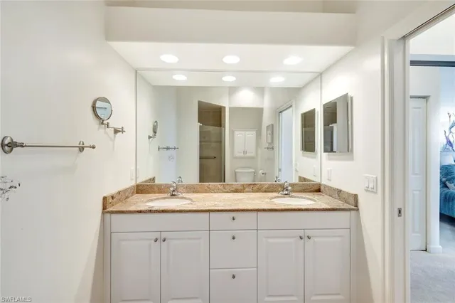 a bathroom with a granite countertop sink mirror and double