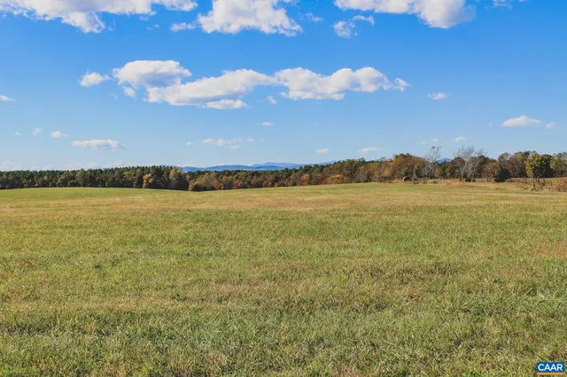 a view of a field with an ocean