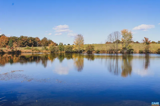 a view of a lake with houses in the back