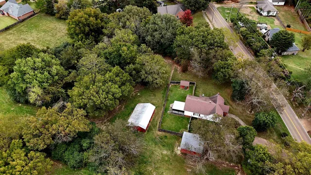an aerial view of house with yard swimming pool and outdoor seating
