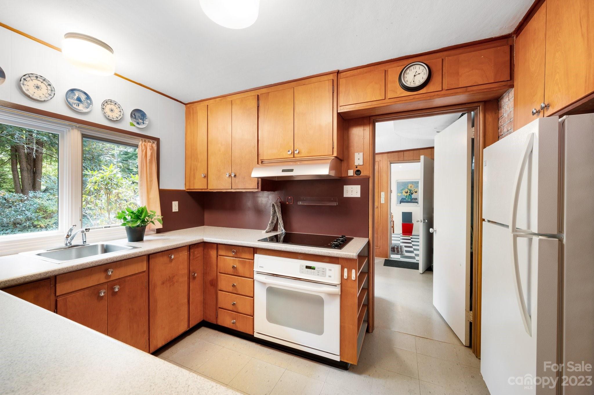 112 Hilltop Road Black Mountain, NC 28711 - Photo 12 of 34 a kitchen with a stove a refrigerator and a sink