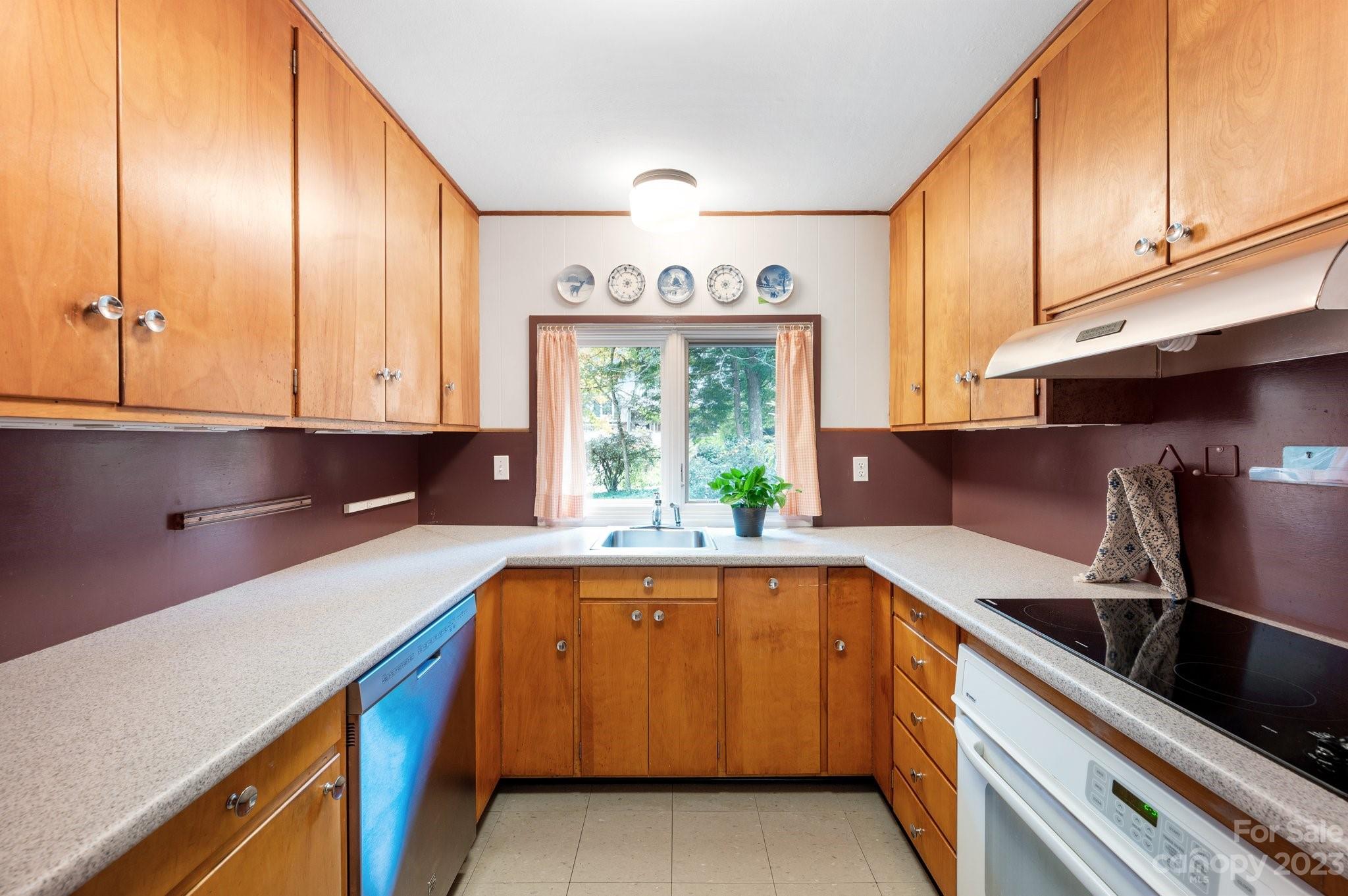 112 Hilltop Road Black Mountain, NC 28711 - Photo 13 of 34 a kitchen that has a sink and a stove