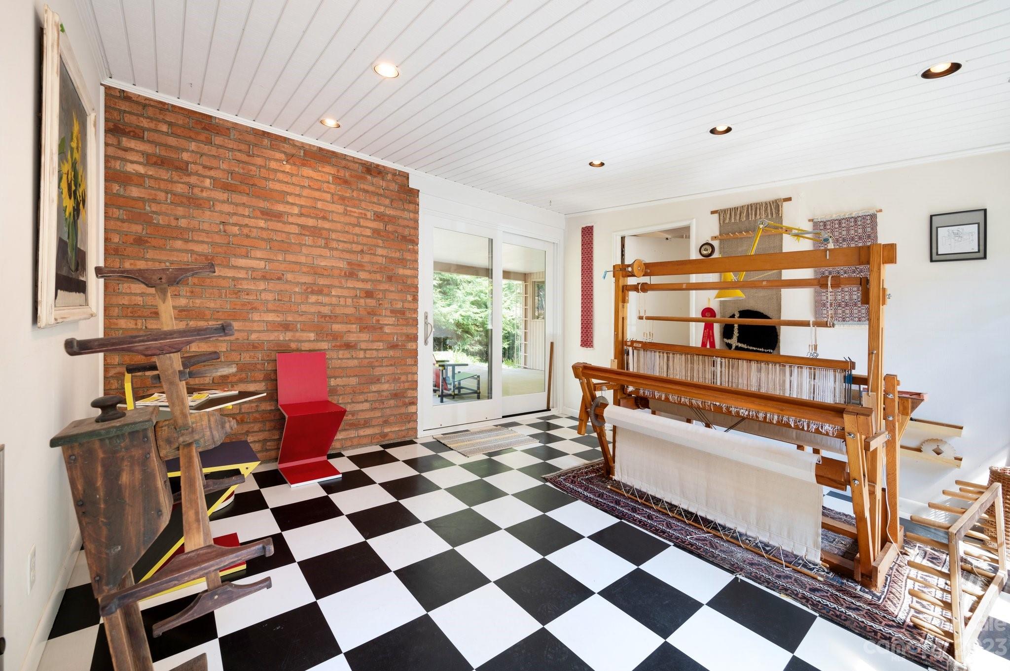 112 Hilltop Road Black Mountain, NC 28711 - Photo 15 of 34 a room with a black white checkered floor and a coffee table