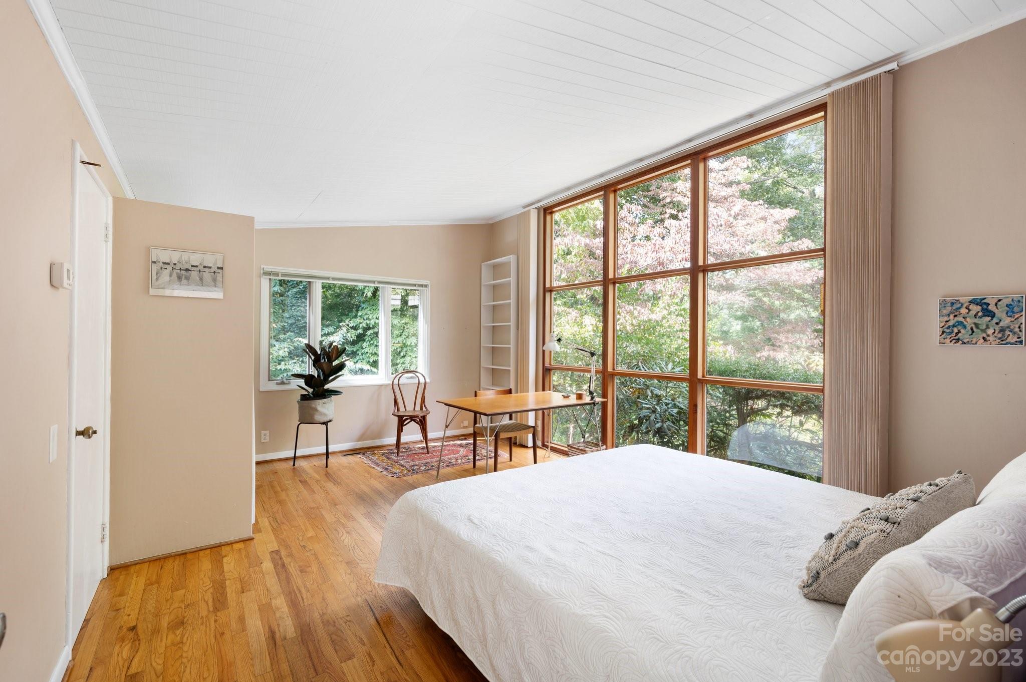 112 Hilltop Road Black Mountain, NC 28711 - Photo 18 of 34 a bed sitting in a bedroom next to a window