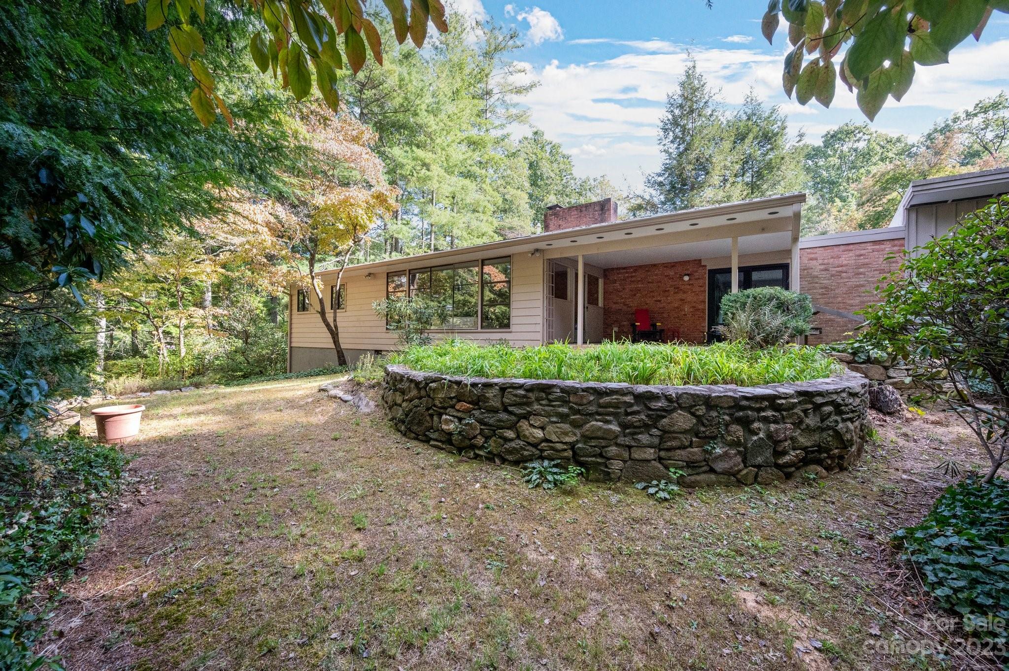 112 Hilltop Road Black Mountain, NC 28711 - Photo 4 of 34 a view of a house with a garden