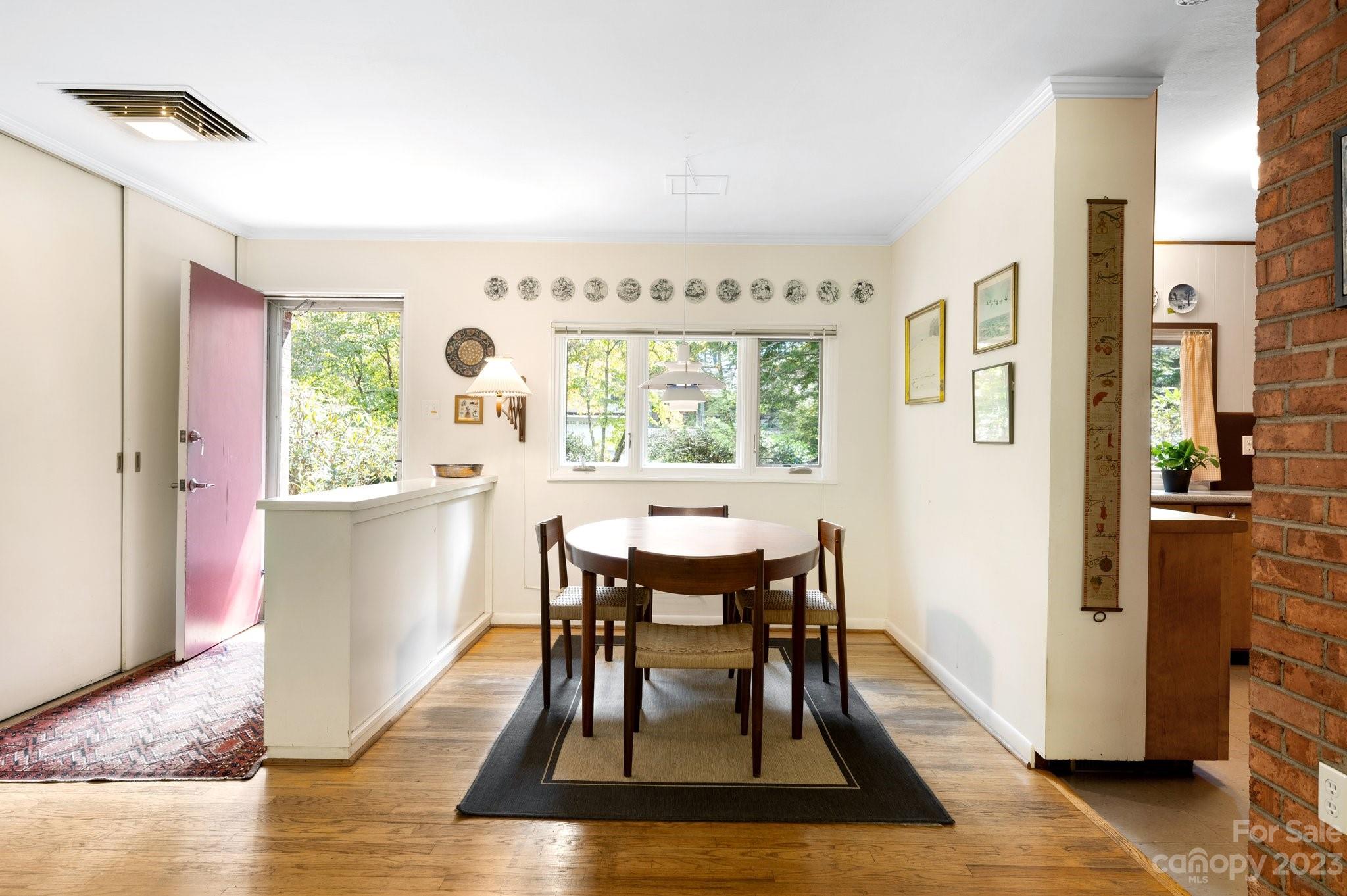 112 Hilltop Road Black Mountain, NC 28711 - Photo 10 of 34 a view of a dining room with furniture window and wooden floor