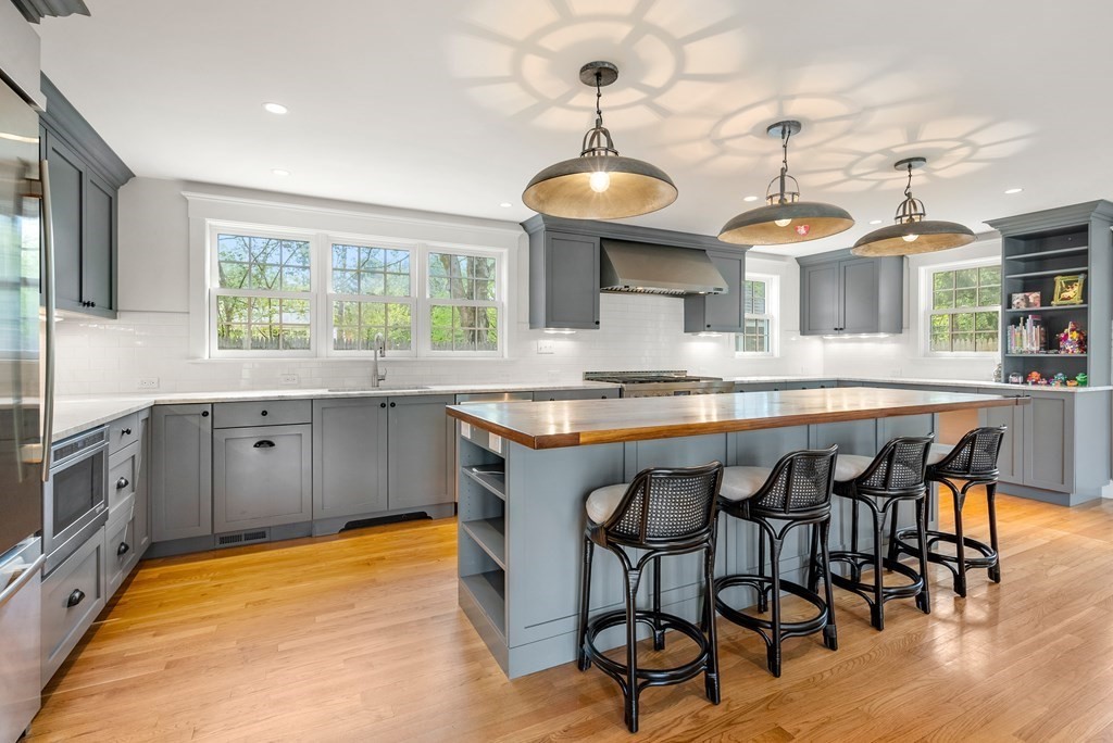 27 Boulder Brook Road Wellesley, MA 02481 - Photo 9 of 41 a kitchen with stainless steel appliances granite countertop a sink a stove and a wooden floors