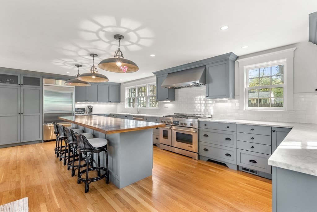 27 Boulder Brook Road Wellesley, MA 02481 - Photo 10 of 41 a kitchen with granite countertop a stove a sink a dining table and chairs