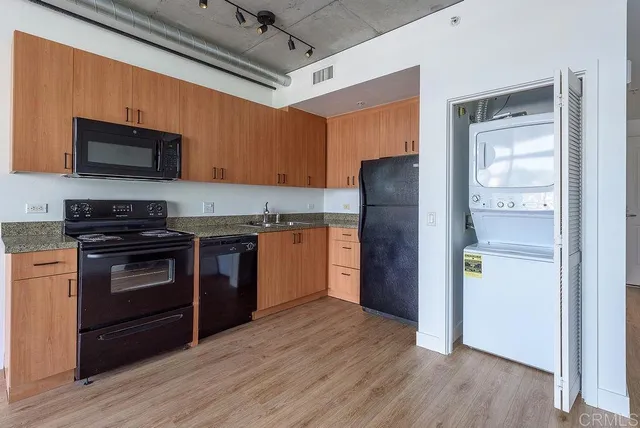 a kitchen with a wooden floor and a stove top oven