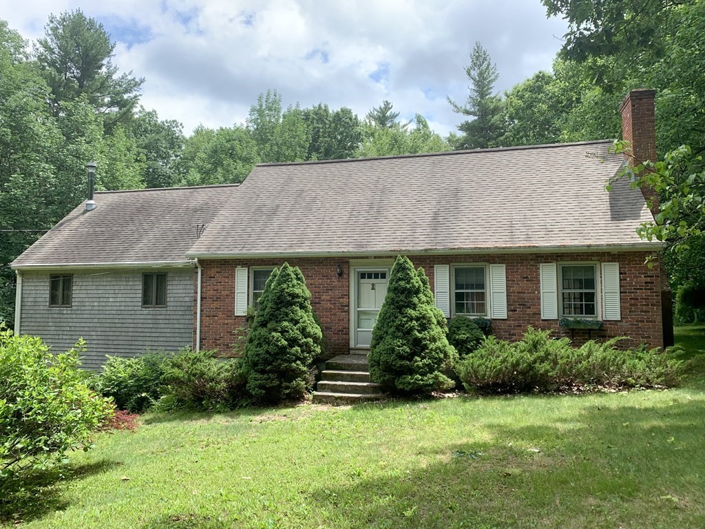 a view of a house with garden and yard